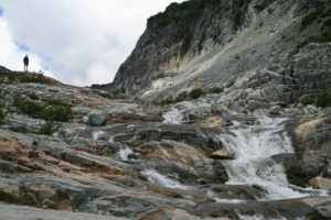 Waterfalls over slick rock, just below the glacier.