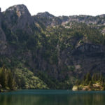 Lake Angeles, with the island in the middle, set against steep rocky cliffs of Klahhane Ridge