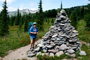 Maria is dwarfed by the huge cairn along the trail...